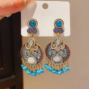 Detail of vintage teardrop earrings with S925 silver needles and blue zircon accents