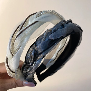 Detail of twisted organza fabric headband with sparkling crystal beads and soft mesh texture