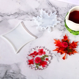 Macro shot of maple leaf silicone molds for DIY resin coasters with floral inserts