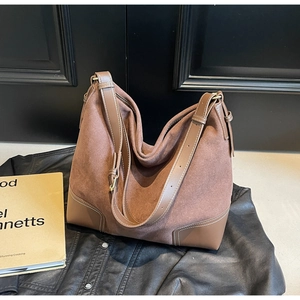 Detail of vintage mocha suede shoulder bag with adjustable PU leather strap and gold buckle
