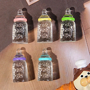 Five miniature resin feeding bottles in various colors for DIY dollhouse crafts