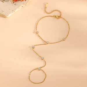 Detail of 18k gold plated slave bracelet with heart design and zircon accents