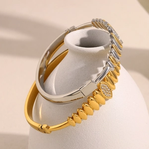Detail of 18K gold and silver plated heart chain bracelets with teardrop zircon inlay