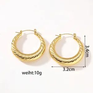 Macro detail of gold 18k plated hollow hoop earrings with spiral twist texture and size specs