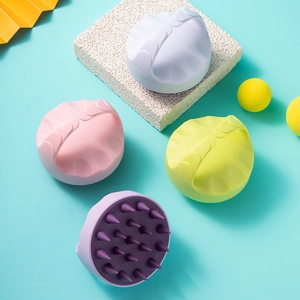 Scalp massager brushes in white, pink, yellow, and purple colors for hair cleaning