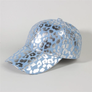 Detailed close-up of light blue denim baseball cap with silver leopard print and curved brim