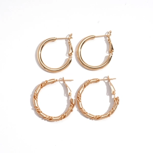 Set of two pairs of minimalist gold geometric hoop earrings with smooth and twisted textures