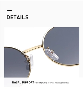 Detail of adjustable soft silicone nose pads on gold metal oval sunglasses