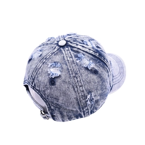 Vintage washed light blue denim baseball cap with distressed details and adjustable buckle