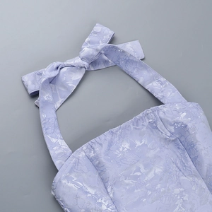 Detail of lavender floral jacquard fabric with halter neckline and bow-tie ribbon