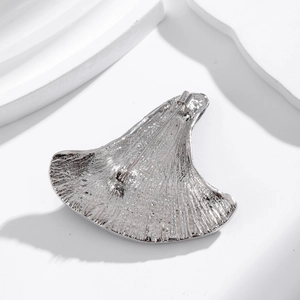 Silver ginkgo leaf alloy brooch back view with textured surface and pin fastening