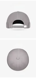 Detail view of the six-panel grey docker cap with adjustable metal buckle and top button