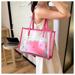 Transparent PVC tote bag featuring pink edges and colorful gemstone embellishments