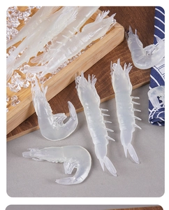 Detailed macro view of realistic translucent PVC prawn model on a wooden plate with ice