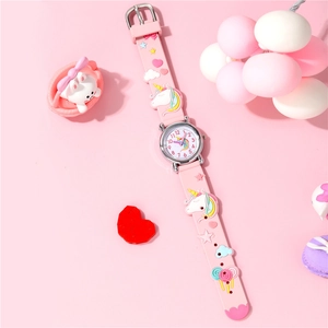 Pink kids watch with unicorn silicone strap and pastel accessories in dreamlike setting