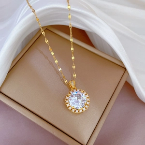 Elegant gold titanium necklace with large round zircon pendant on silk background