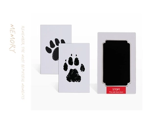 Detail of inkless paw print kit with black ink pad and white memory collection cards