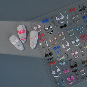 Detail of 3D embossed bikini nail art stickers with colorful patterns and FEB-97 design