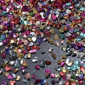 Macro shot of colorful irregular glass crushed stones for nail art and DIY jewelry
