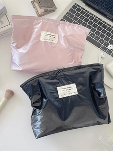 Glossy silver finish makeup storage bags in pink and black with stylish fabric label