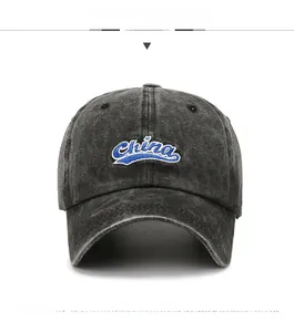 Detail of vintage washed black baseball cap featuring blue and white China embroidery