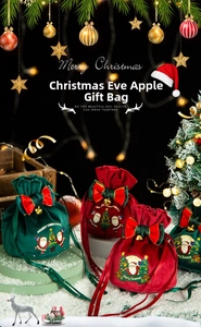 Detail of red and green velvet Christmas gift bags with bells and ribbon drawstrings