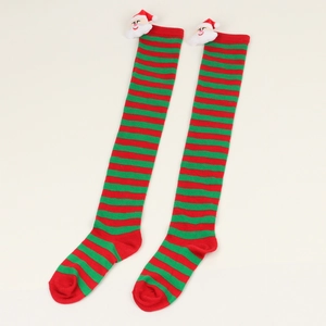 Close-up of red and green striped Christmas socks with 3D Santa Claus plush ornaments