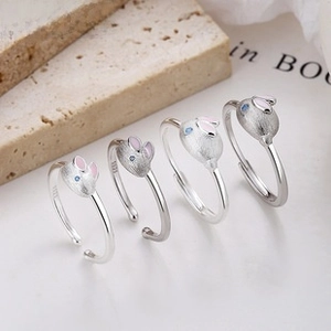 Macro shot of S925 sterling silver rabbit rings with moonstone and brushed texture