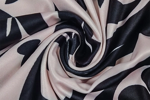 Detail of silky striped fabric with black, white and pink abstract geometric patterns