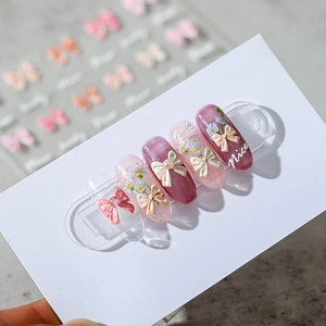 3D resin bow and daisy nail art stickers on purple and pink press-on nails