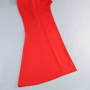 Detail of red evening dress hem showing smooth drape and high-quality woven fabric