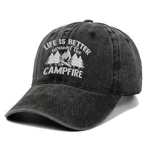 Close-up of white embroidery on a charcoal grey washed cotton baseball cap for campers