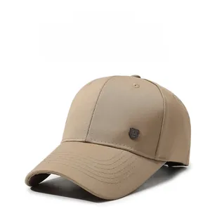 Detailed side view of a khaki baseball cap featuring a metal shield emblem with an R letter