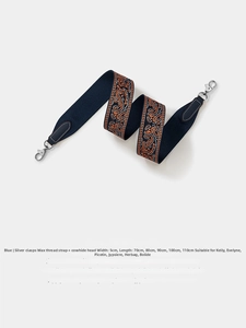 Detail of blue 5cm wide retro woven strap with orange embroidery and silver metal clasps
