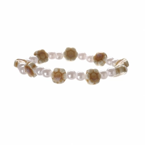 Minimalist pearl beaded bracelet with ceramic flower accents on a clean white background