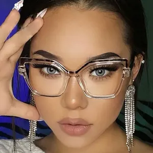 Close-up of transparent cat-eye frames with leopard print trim and rhinestone earrings