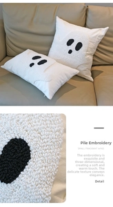 Detailed view of the 3D chenille embroidery ghost texture on white festive cushion covers
