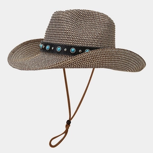 Close-up of brown western straw hat featuring turquoise beads and metal studs