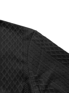 Close-up of black men's shirt showing diamond jacquard texture and shoulder stitching