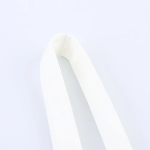 Macro shot of white woven fabric texture and bow detail on the v-neck summer dress