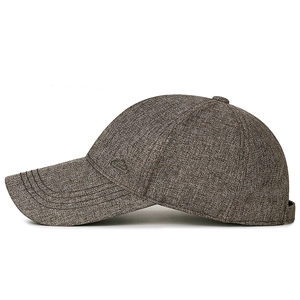 Structured greyish-brown baseball cap with peak metal badge and adjustable strap
