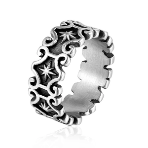 Vintage stainless steel ring with sun totem and scroll engravings on white background