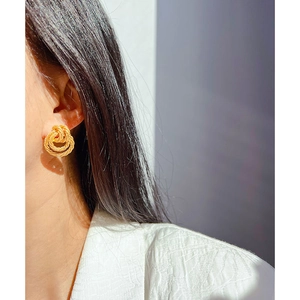 Vintage style gold twisted rope hoop earrings for women shown on model for elegant look