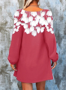 Detail view of the back of a red floral long sleeve dress with white tulip patterns
