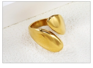 Close-up of a high-polished 18k gold-plated irregular knot ring with smooth organic shapes