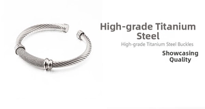 Macro detail of silver stainless steel twisted cable cuff bracelet with smooth band accents