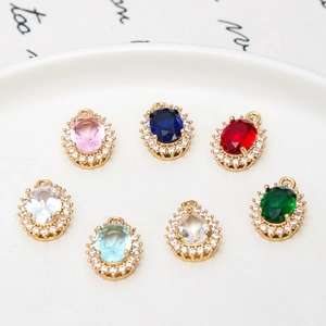 Macro shot of colorful oval and teardrop crystal pendants in gold-plated settings
