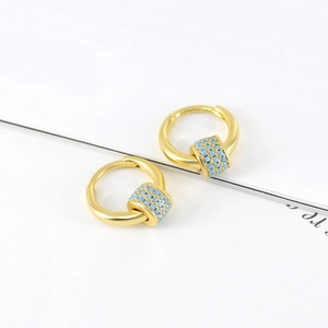 Golden round hoop earrings with rotating light blue stone charms for a stylish look