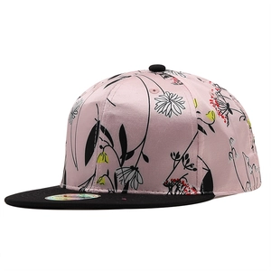 Pink satin snapback cap with floral print and flat black brim on a white background