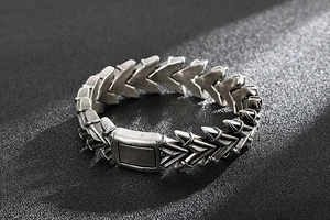 Detailed close-up of punk style silver steel arrow link bracelet with rectangular clasp